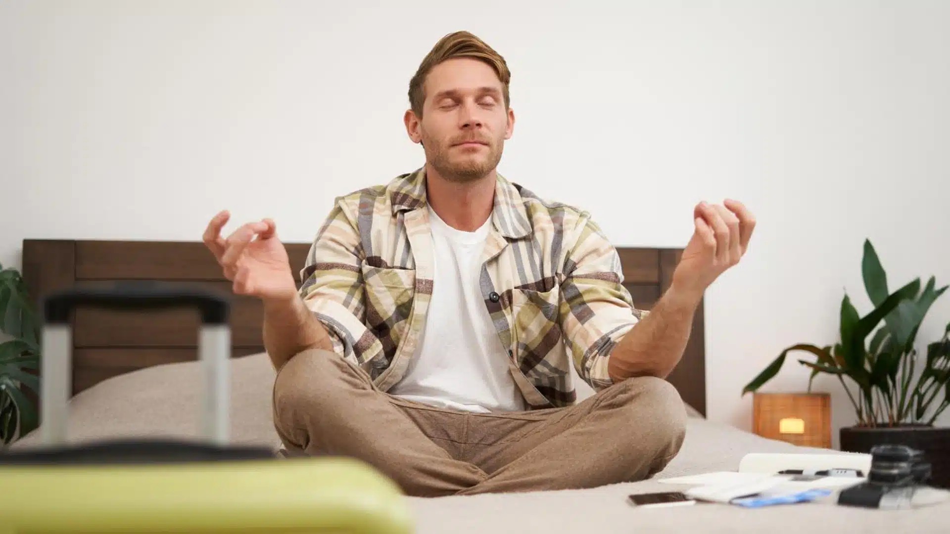 Man practicing meditation on bed for stress relief and better sleep