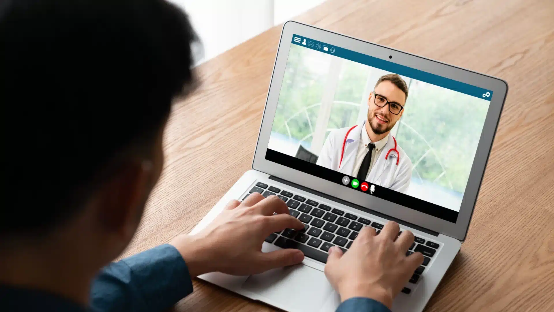 Patient video call with doctor on laptop